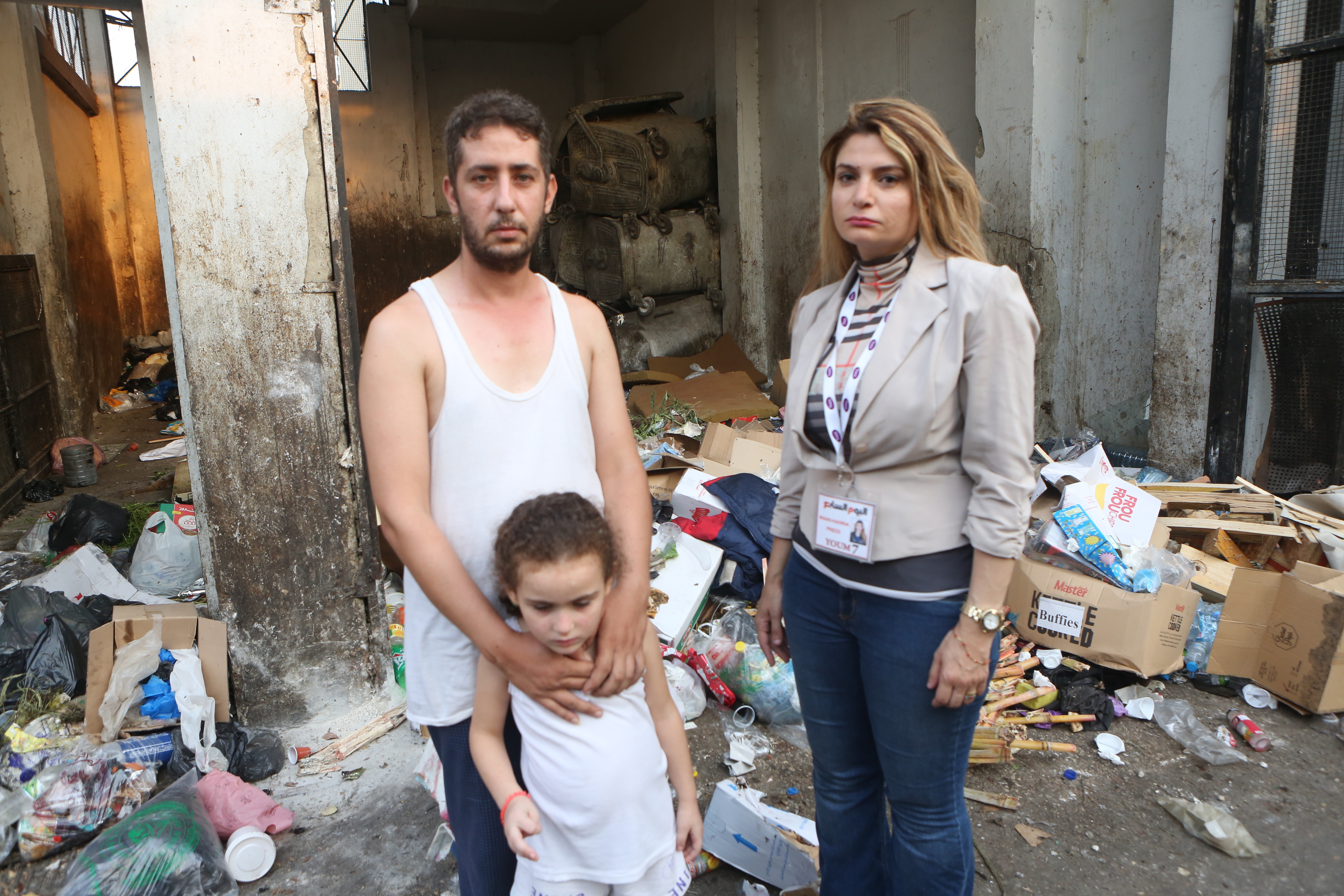 Ali Al Far with his daughter who is sick because of garbage bugs