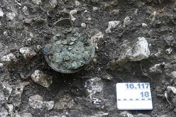 The ceramic pot with the coins during professional excavation by employees of Archaeology Baselland. (Archaeology Baselland)