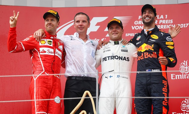 Mercedes' Valtteri Bottas celebrates his win on the podium with Ferrari's Sebastian Vettel and Red Bull's Daniel Ricciardo / Reuters 