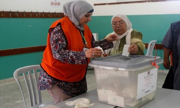 A Palestinian woman casts her ballot at a polling station during municipal elections in the northern West Bank town of Anabta, near Tulkarm - REUTERS