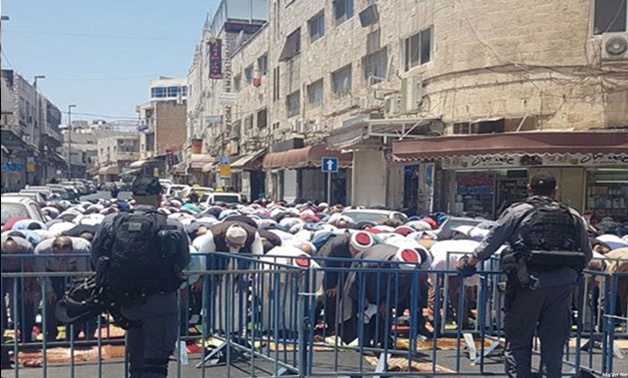 Palestinians pray in the streets of Jerusalem after denied Friday prayers at Al-Aqsa - Phoot credit Middle East Monitor Twitter account