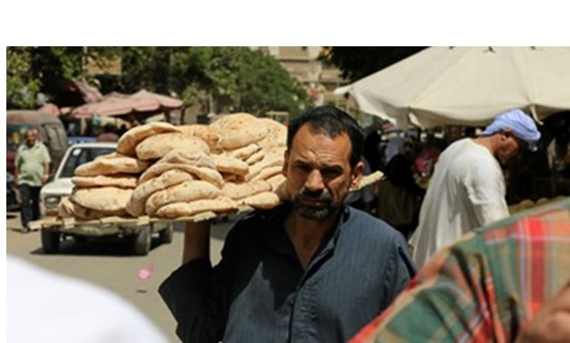 A citizen buys subsidized bread - File Photo