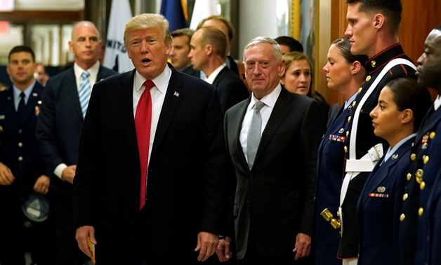 Secretary of Defense James Mattis (R) escorts U.S. President Donald Trump as he greets military personnel after attending a meeting at the Pentagon in Arlington, Virginia, U.S. July 20, 2017. REUTERS/Kevin Lamarque