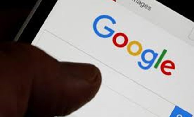 FILE PHOTO: A man holds his smartphone which displays the Google home page, in this picture illustration taken in Bordeaux, Southwestern France, August 22, 2016.

