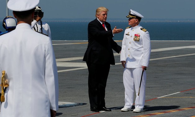 U.S. President Donald Trump is greeted by U.S. Navy Captain Richard McCormack as he arrives on deck to commission the aircraft carrier USS Gerald R. Ford at Naval Station Norfolk in Norfolk - REUTERS