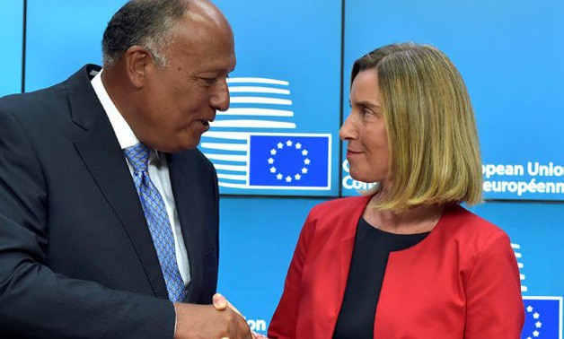 Federica Mogherini (R), High Representative of the European Union for Foreign Affairs and Security Policy, shakes hands with Minister of Foreign Affairs, Sameh Shoukry (L) in Brussels - Reuters