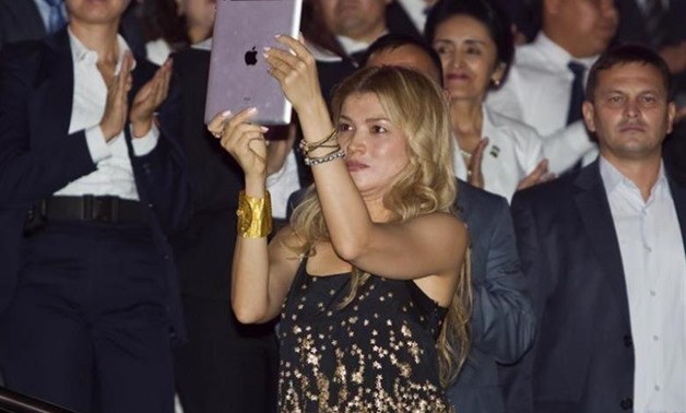 Gulnara Karimova (C), daughter of Uzbekistan's President Islam Karimov, takes a video with an Ipad as her father dances during an Independence Day celebration in Tashkent August 31, 2012 - Reuters