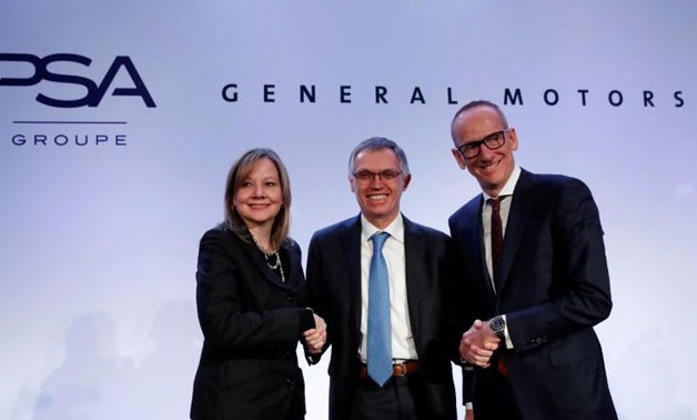 FILE PHOTO: Carlos Tavares (C), Chairman of the Managing Board of French carmaker PSA Group, Mary Barra (L), chairwoman and CEO of General Motors, and Dr Karl-Thomas Neumann, Chairman of the Management Board Opel Group GmbH, pose during a news conference 