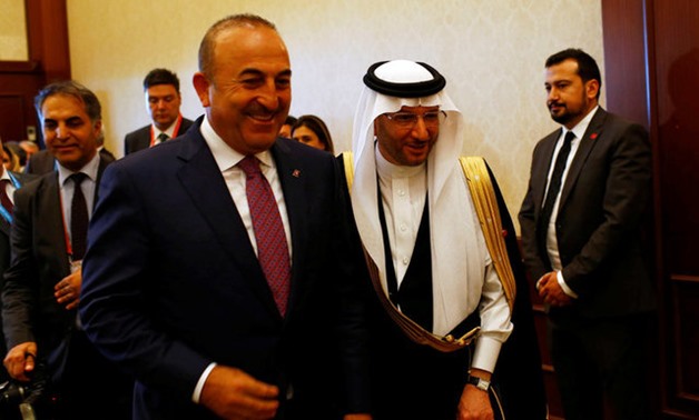 Secretary General of Organization of Islamic Cooperation (OIC) Yousef bin Ahmad Al-Othaimeen and Turkish Foreign Minister Mevlut Cavudoglu arrive at a news conference after an extraordinary meeting of the OIC Executive Committee in Istanbul, Turkey, Augus