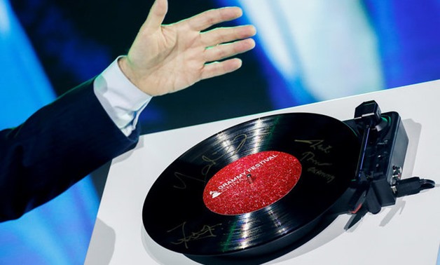A record signed by representatives of the Recording Academy, Bravo Entertainment and China Music Vision spins on a player during a ceremony in Beijing marking a Chinese partnership to create the Grammy Festival China, August 3, 2017. REUTERS