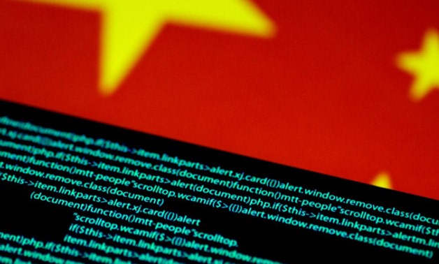 Computer code is seen on a screen above a Chinese flag in this July 12, 2017 illustration photo