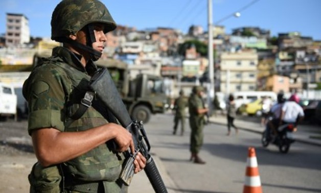 © AFP/File | Brazilian soldiers patrol in Rio de Janeiro in 2014
