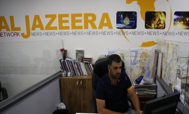 Ahmad Gharabli, AFP | Employees of Qatar-based news network and TV channel Al-Jazeera are seen at their Jerusalem office on July 31, 2017.