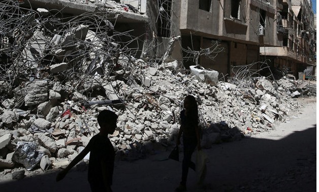 Children walk past rubble of damaged buildings at Ain Tarma, eastern Damascus suburb of Ghouta MIDEAST-CRISIS/SYRIA Children walk past rubble of damaged buildings at Ain Tarma, eastern Damascus suburb of Ghouta Children walk past rubble of damaged buil