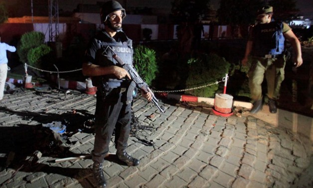 A policeman stands guard after a blast in Lahore - Reuters