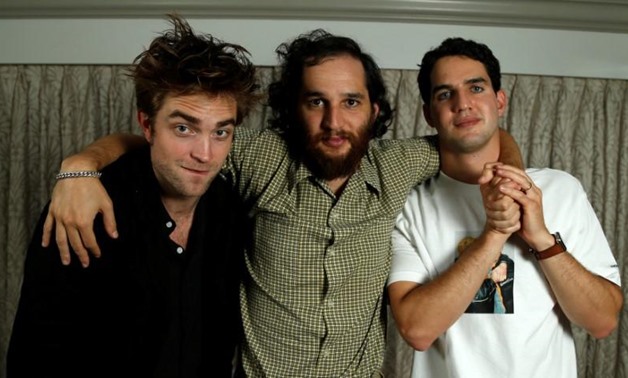 Cast member Robert Pattinson (L) and directors Joshua (C) and Ben Safdie pose for a portrait while promoting the film "Good Time" in Los Angeles, Reuters