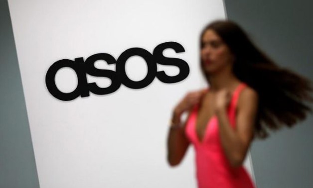 A model walks on an in-house catwalk at the ASOS headquarters in London April 1, 2014 - Reuters