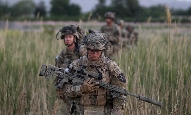 U.S. soldiers from 5-20 infantry Regiment attached to 82nd Airborne walk while on patrol in Zharay district in Kandahar province, southern Afghanistan April 24, 2012.