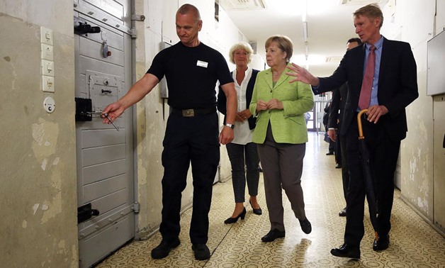 Monika Gruetters, German Chancellor Angela Merkel and director Hubertus Knabe visit a former Stasi prison in Berlin-Hohenschoenhausen in Berlin, Germany, August 11, 2017 - REUTERS
