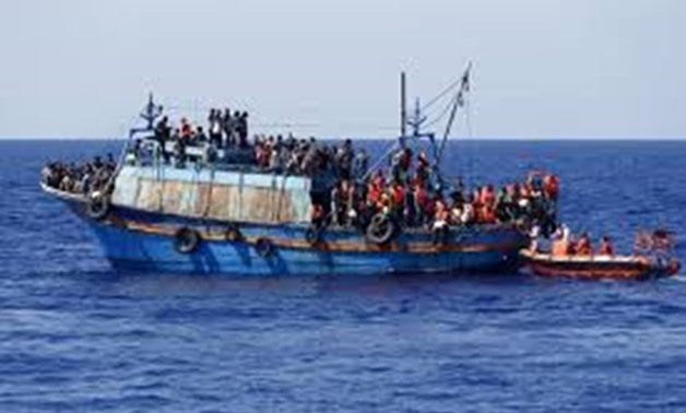 FILE PHOTO - Migrants on board an overloaded wooden boat are rescued some 10.5 miles (16 km) off the coast of Libya August 6, 2015.
