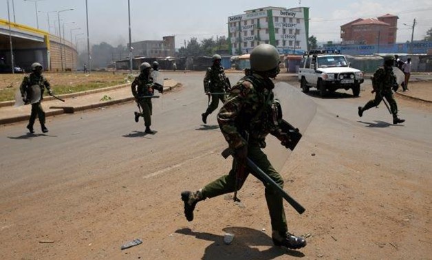 Policemen chase protesters in Kisumu, Kenya August 11, 2017. © 2017 Baz Ratner /Reuters
