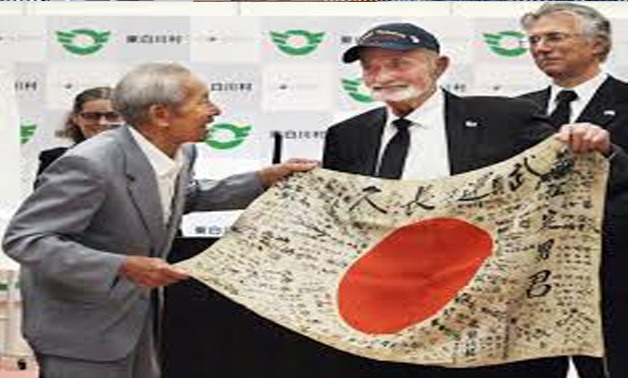 U.S. World War Two veteran Marvin Strombo (C) meets with Tatsuya Yasue (L), brother of Sadao Yasue, to hand over a Japanese flag Strombo found in a battlefield in 1944, in Higashi-Shirakawa Village, Japan, in this photo taken by Kyodo August 15, 2017. Man