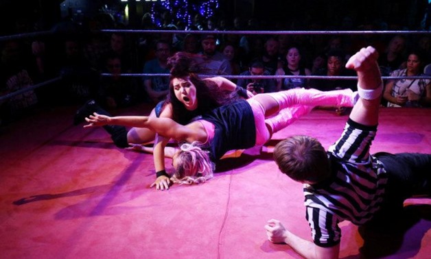 Wrestlers perform at an all female wrestling event in London - Reuters