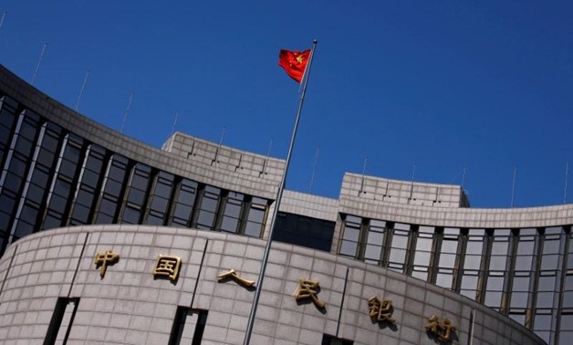 A Chinese national flag flutters outside the headquarters of the People's Bank of China, the Chinese central bank, in Beijing, China April 3, 2014.
Petar Kujundzic/File Photo
