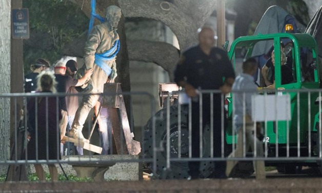 Workers remove Confederate General Robert E. Lee statue from the south mall of the University of Texas in Austin, Texas
