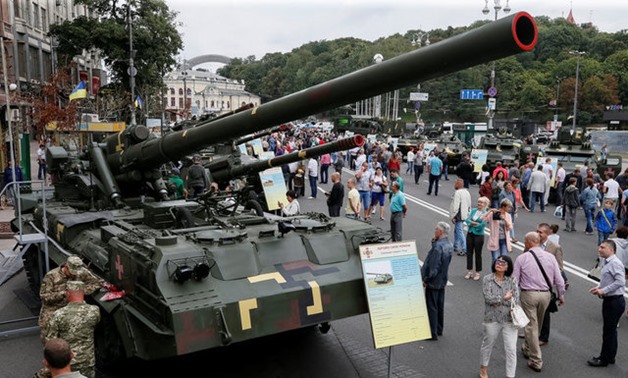 People attend an exhibition of Ukrainian military vehicles in Kiev - REUTERS