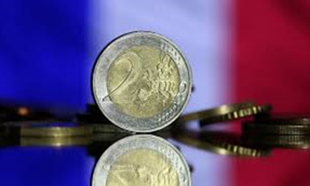 Euro coins are seen in front of displayed France flag in this picture illustration taken May 7, 2017.
