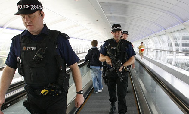 Armed police officers walk through Manchester Airport in northern England (Reuters/Darren Staples) / Reuters
