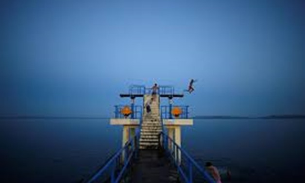 A man jumps off a diving board at night in Salthill, County Galway, Ireland, July 17, 2017.
Clodagh Kilcoyne