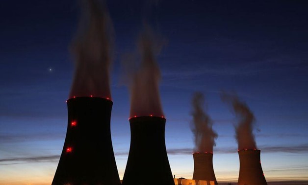 Steam rises at night from the cooling towers - REUTERS