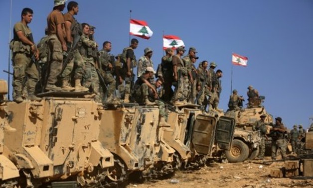Lebanese soldiers stand on armoured vehicles on a hill they took from the Islamic State (IS) group in Jurud Ras Baalbek on the Syrian-Lebanese border, on August 28, 2017