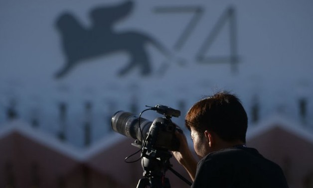A journalist stands in front of a logo of the 74th Venice Film Festival on August 29
Filippo Monteforte, AFP 
