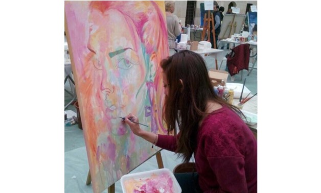 Lamya al-Sayed and her art work (official Facebook page)