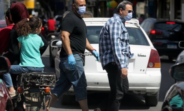 FILE - Citizens wearing masks in Cairo, Egypt - Reuters