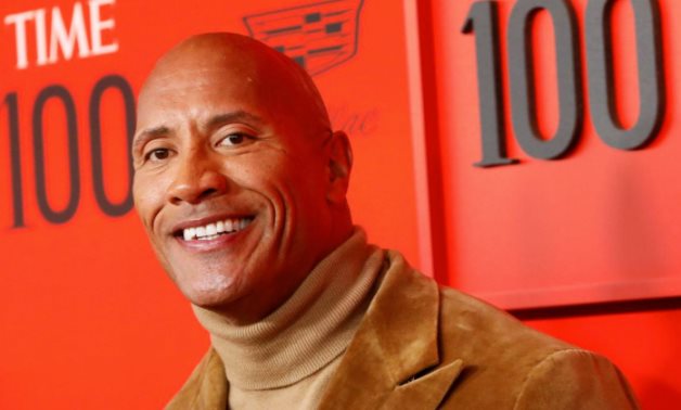 FILE PHOTO: Dwayne "The Rock" Johnson poses upon arriving for the Time 100 Gala celebrating Time magazine's 100 most influential people in the world in New York - REUTERS/Andrew Kelly/File Photo
