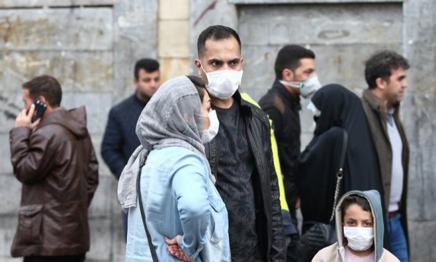 Iranian family wear protective masks to prevent contracting a coronavirus, as they stand at Grand Bazaar in Tehran, Iran February 20, 2020. WANA (West Asia News Agency)/Nazanin Tabatabaee via REUTERS