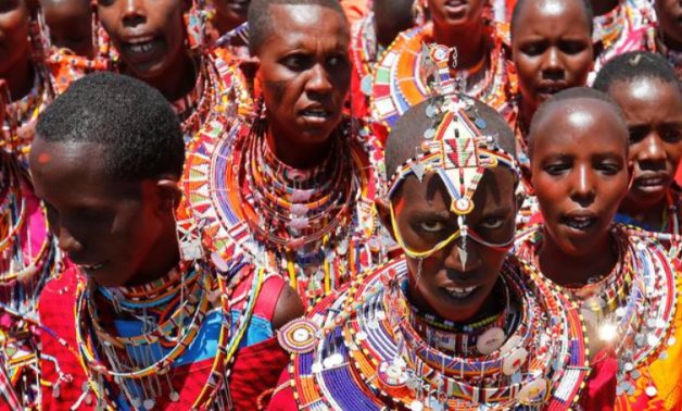 Maasai women sing for their men of Matapato clan before attending the Olng'esherr (meat-eating) passage ceremony to unite two age-sets ts - - Reuters/ Thomas Mukoya