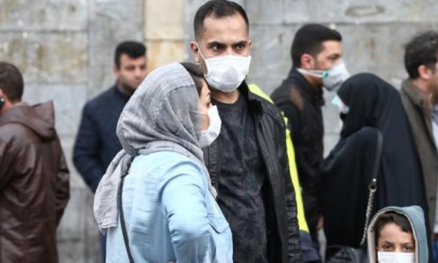 Iranian family wear protective masks to prevent contracting a coronavirus, as they stand at Grand Bazaar in Tehran, Iran February 20, 2020. WANA (West Asia News Agency)/Nazanin Tabatabaee via REUTERS