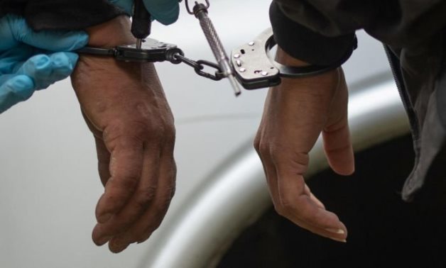 FILE – Handcuffed person – Reuters 
