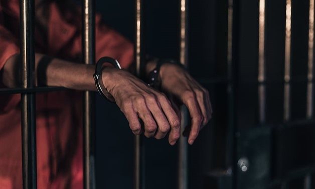 FILE - A handcuffed person inside a prison – Pxfuel
