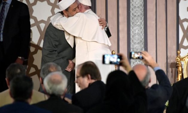 FILE- Pope Francis of the Vatican extends his greetings to Grand Imam of Al Azhar and Chairman of the Muslim Council of Elders Ahmad el Tayeb in April 2017 in Cairo- press photo