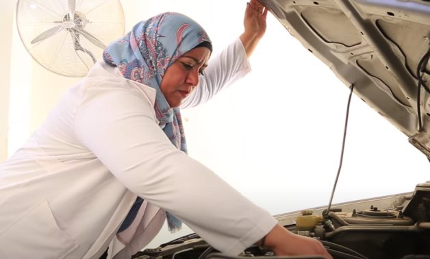 FILE - Egyptian woman working as mechanic 