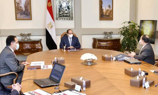 Egypt's President Abdel Fattah El-Sisi meets with Prime Minister Mostafa Madbouli and Minister of Finance Mohamed Maeet to review the budget of the new fiscal year 2021-2022. - Presidency