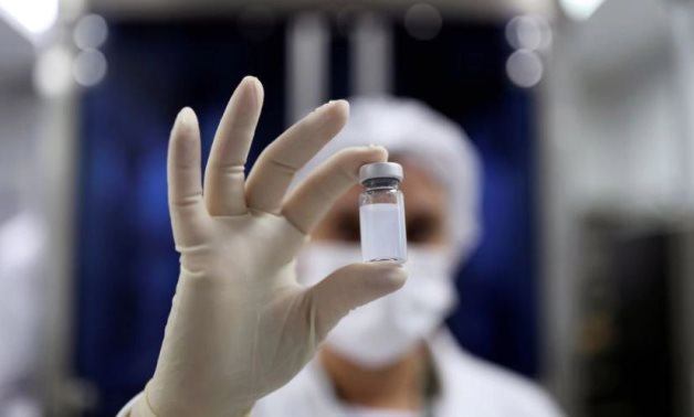 FILE: An employee holds a vial containing CoronaVac, Sinovac Biotech's vaccine against the coronavirus disease – Reuters 