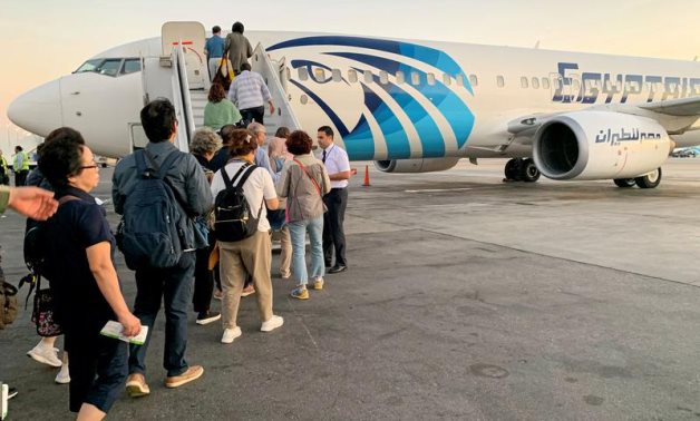 FILE - Tourists take Luxor-bound EgyptAir flight from Cairo International Airport in Cairo, Egypt October 9, 2019 - Reuters