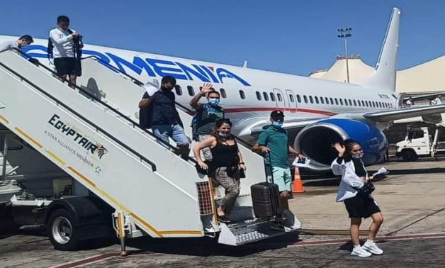 Passengers getting off the first Armenia Airways plane landing in Sharm El Sheikh International Airport on August 17, 2021. Press Photo 